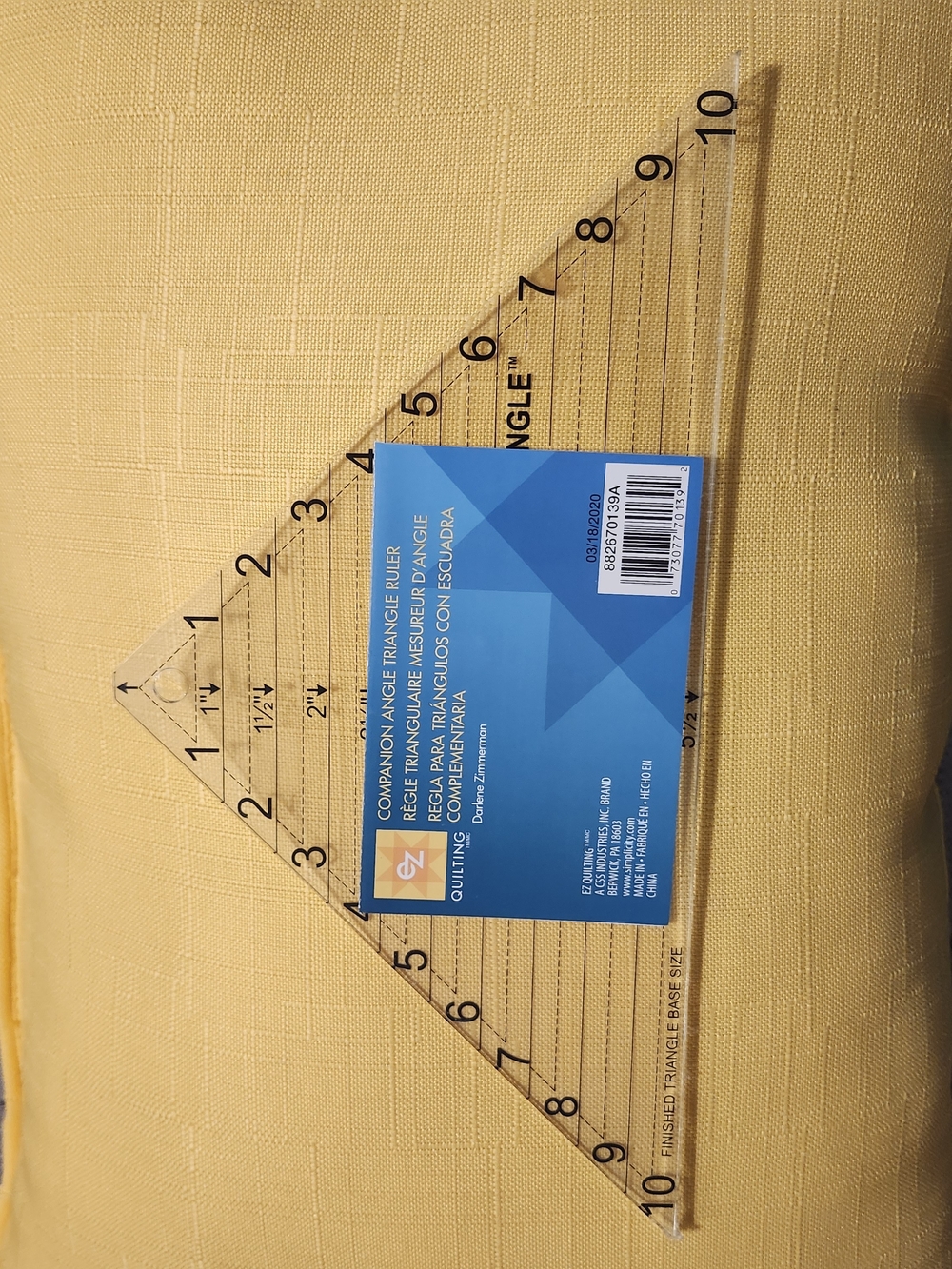 Clear Acrylic Triangular Quilting Ruler with Blue Label - Yellow Background